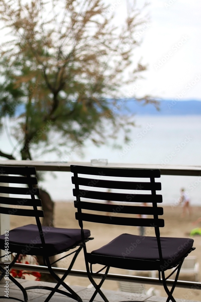 Wooden chairs in a cafe. Outdoor cafe on a beach. Selective focus.