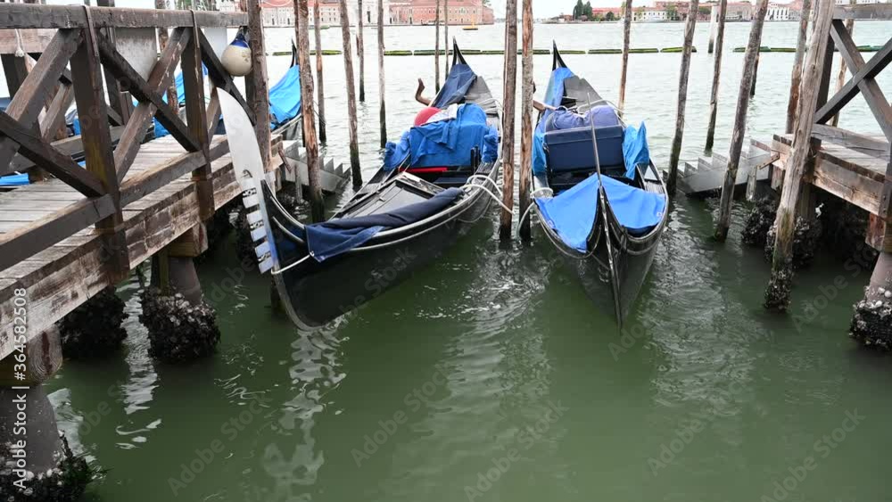 Venice, Italy - gondolas and gondoliers in the Grand Canal near the Rialto Bridge, in the San Marco Basin and between the canals of the lagoon city Venice, Italy - gondolas and gondoliers in the Grand Canal near the Rialto Bridge, in the San Marco Basin and between the canals of the lagoon city
