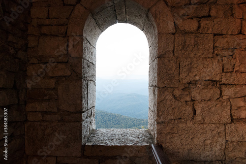 mountain view from the window arches in the concrete wall