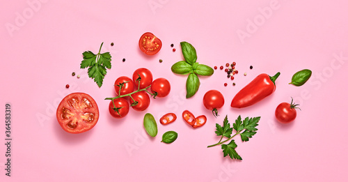 Fototapeta Naklejka Na Ścianę i Meble -  Tomato, basil, spices, bell chili pepper. Vegan diet food, creative composition on pink. Fresh basil, herb, cherry tomatoes layout, cooking sauce colorful concept, top view.
