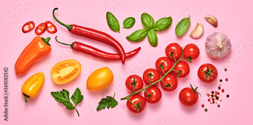 Fototapeta Naklejka Na Ścianę i Meble -  Tomato, basil, spices, bell chili pepper, garlic. Vegan diet food, creative composition on pink. Fresh basil, herb, cherry tomatoes layout, cooking sauce colorful concept, top view.