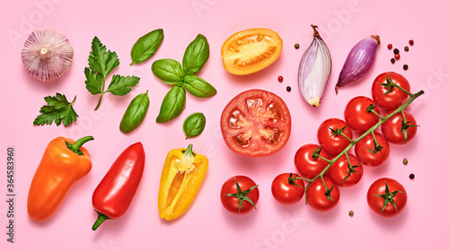 Fototapeta Naklejka Na Ścianę i Meble -  Tomato, basil, spices, bell chili pepper, garlic. Vegan diet food, creative composition on pink. Fresh basil, cherry tomatoes, bell pepper layout, cooking colorful concept, top view.