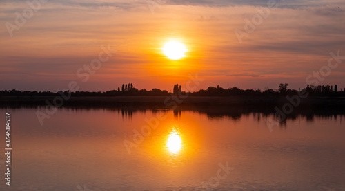 beautiful orange sunset on the lake on a summer day  panoramic shot