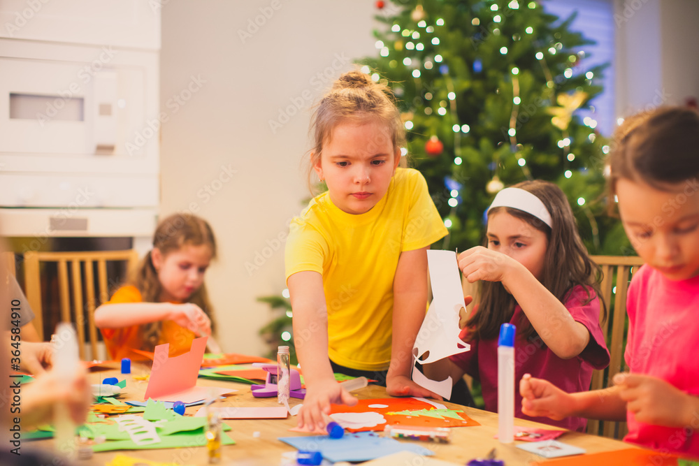Fototapeta premium Girl trying to reach bottle of glue while creative workshop