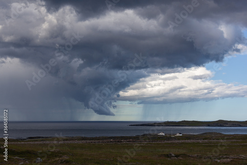 Dramatic thunderclouds with rain over Barents sea, Finnmark, Norway