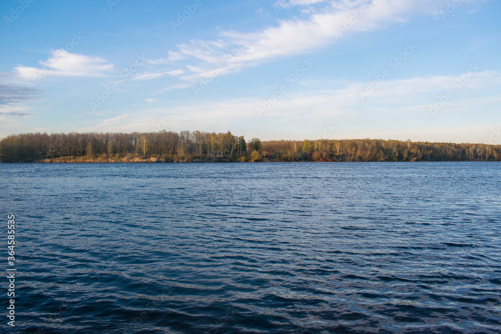 River with small waves, in the distance you can see the opposite Bank with a forest River with small waves, in the distance you can see the opposite Bank with a forest