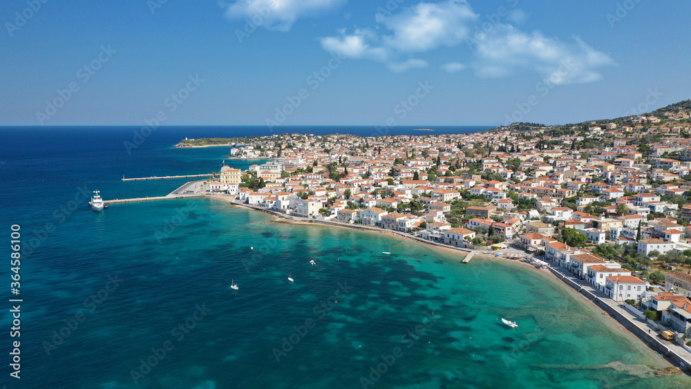 Aerial drone bird's eye view photo of picturesque neoclassic houses in historic and traditional island of Spetses with emerald clear waters, Saronic Gulf, Greece