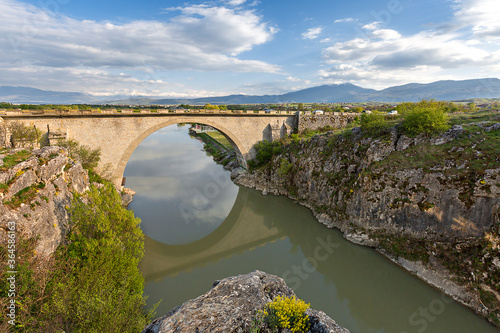 Old bridge with its reflections in water, near Prizren, Kosovo.