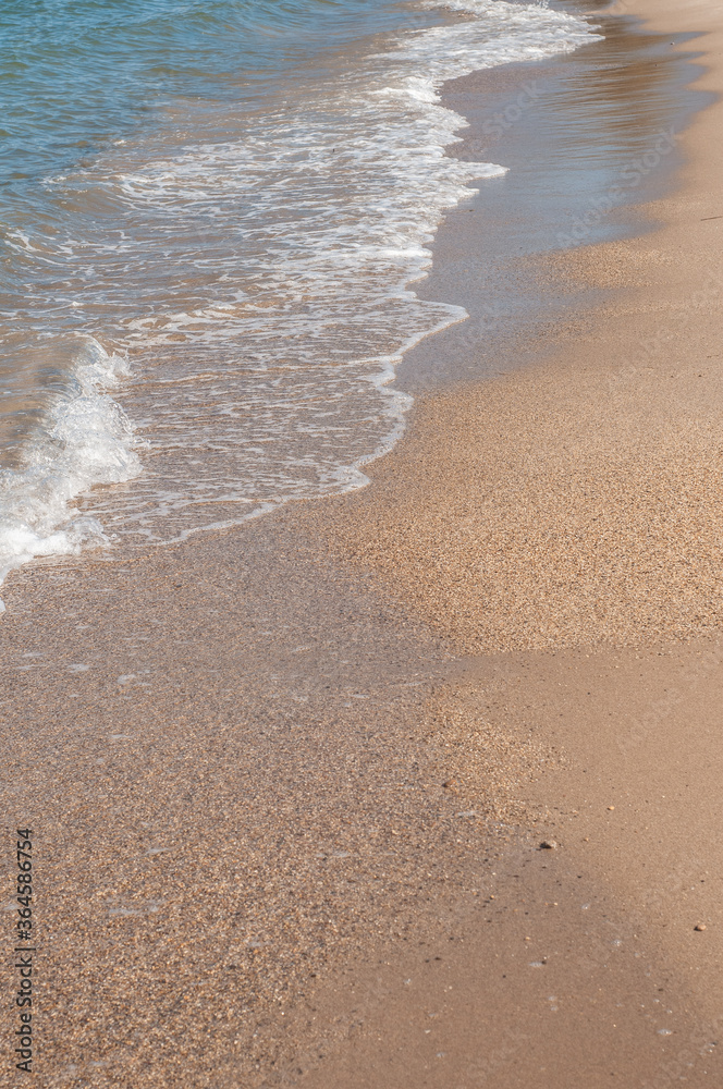 Transparent sea waves on the warm sandy seashore. Sea vacation and travel. Transparent sea waves on the warm sandy seashore. Sea vacation and travel.