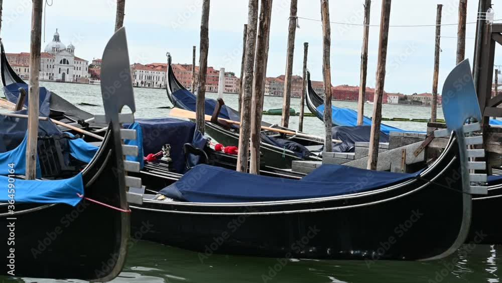 Venice, Italy - gondolas and gondoliers in the Grand Canal near the Rialto Bridge, in the San Marco Basin and between the canals of the lagoon city Venice, Italy - gondolas and gondoliers in the Grand Canal near the Rialto Bridge, in the San Marco Basin and between the canals of the lagoon city