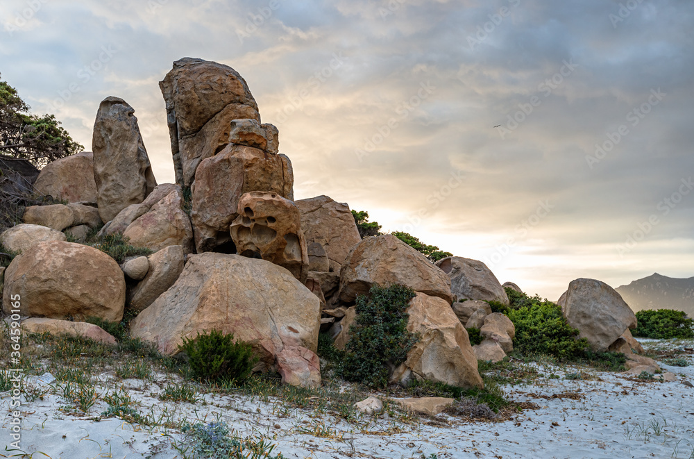 Scenic sunset view of the rocky coast in Sardinia with unique rocks formations.  Holidays, the best beaches in Sardinia, Italy.