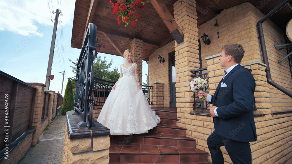 Fototapeta premium The groom meets his bride and gives her a bouquet.