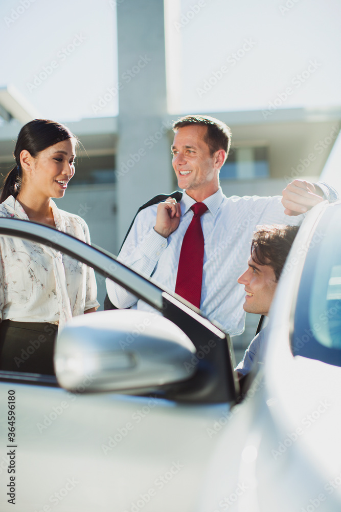 Business people talking at car Business people talking at car