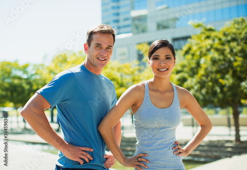 Smiling joggers in urban park