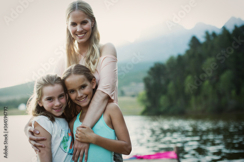 Mother and daughters smiling at lakeside © Paul Bradbury/KOTO