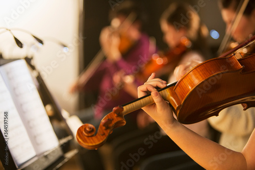 Violinist performing in orchestra
