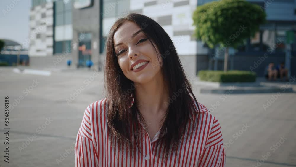 Portrait of a happy carefree woman smiling in front of city background, Close-up face of young woman smiling with teeth outdoors. Portrait of a happy carefree woman smiling in front of city background, Close-up face of young woman smiling with teeth outdoors.