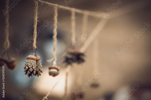 decoration made of forest materials, pine cones and acorns hanging on a thread