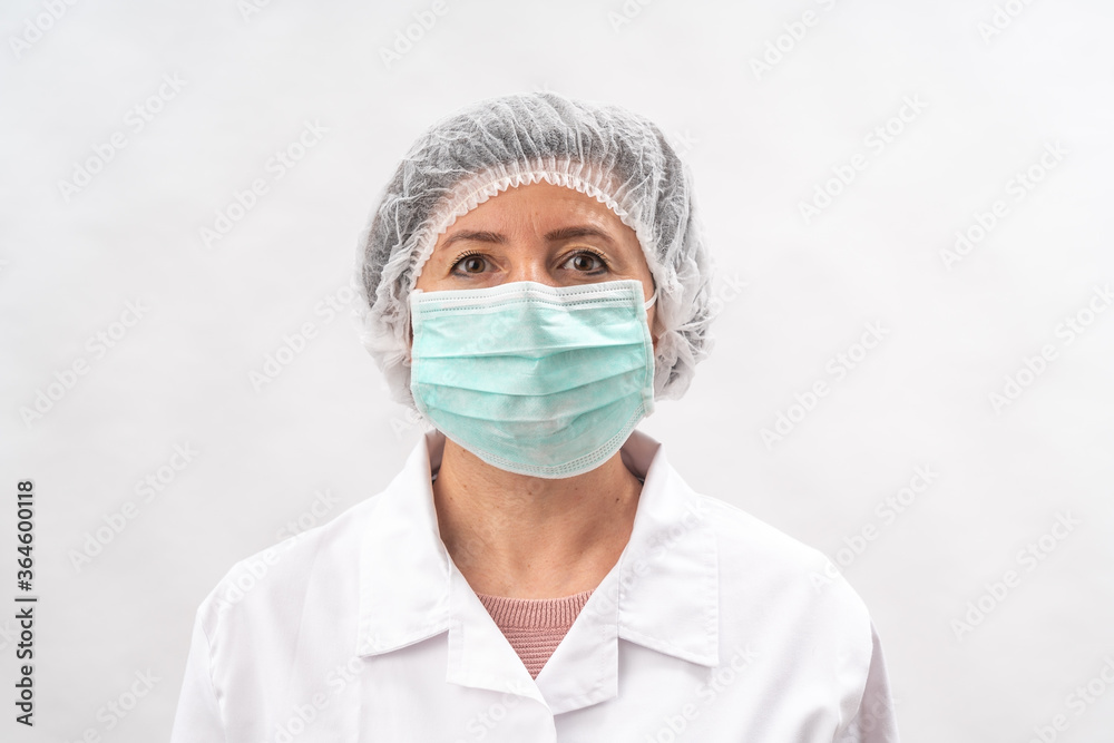 Tired female medic, nurse in protective equipment and a mask from viruses, on a white background. Tired female medic, nurse in protective equipment and a mask from viruses, on a white background.
