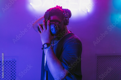 Man in a cyber helmet. New VR games in the neon room. © callisto