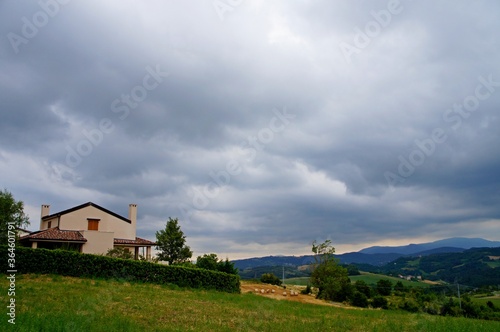 rural landscape with a house and clouds