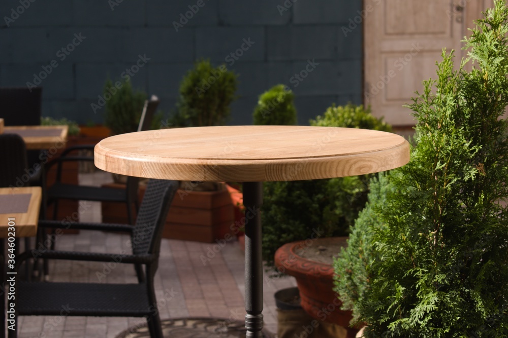 Fototapeta premium wooden round table in open air cafe
