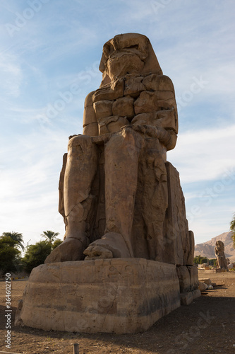 Colossi of Memnon Luxor Thebes against the background of dawn in the Egypt