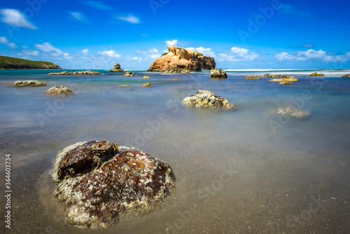 Fototapeta Naklejka Na Ścianę i Meble -  Long exposure shot of rocks along a tropical beach at Hodges Bay near Calibishie on the Caribbean island nation of Dominica