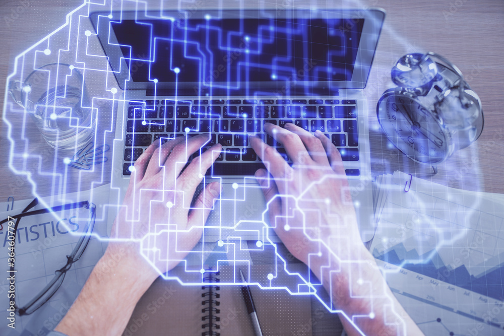 Double exposure of man's hands typing over computer keyboard and brain hologram drawing. Top view. Ai and data technology concept. Double exposure of man's hands typing over computer keyboard and brain hologram drawing. Top view. Ai and data technology concept.