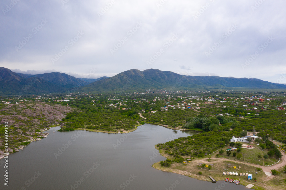 Aerial view of the lake and mountains with village below
