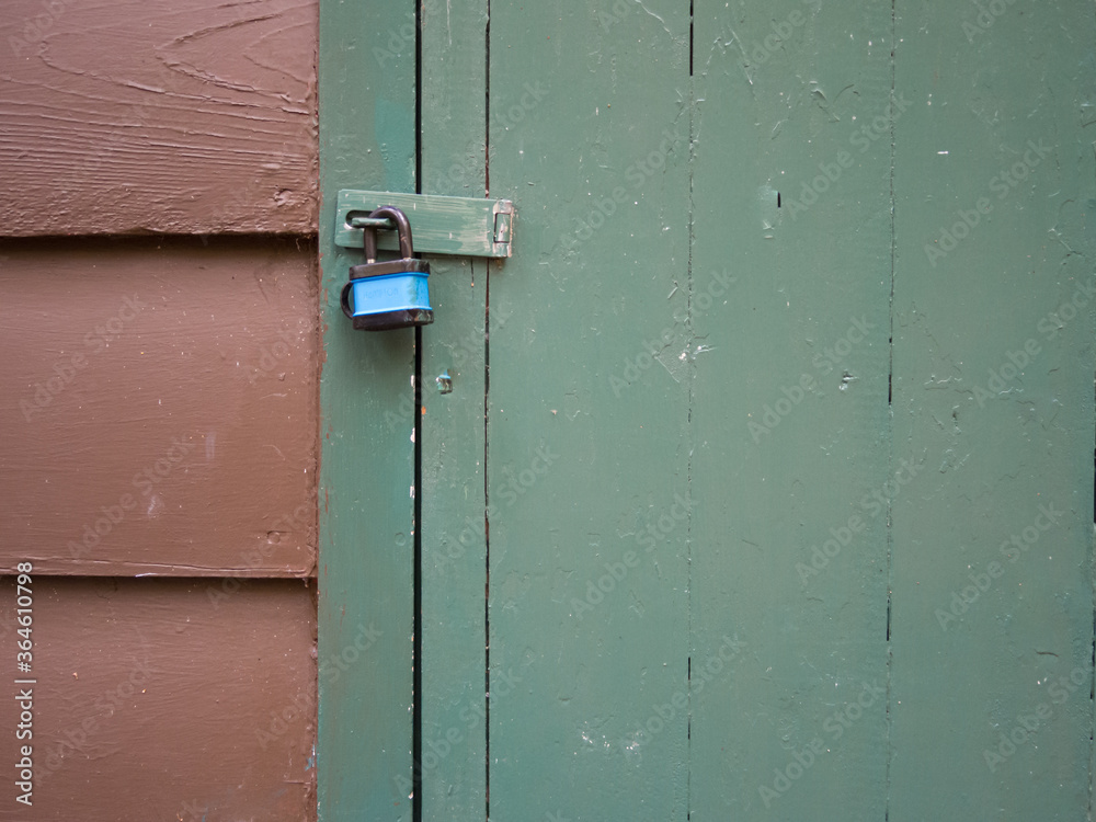 Door latch locked with a flimsy padlock Door latch locked with a flimsy padlock