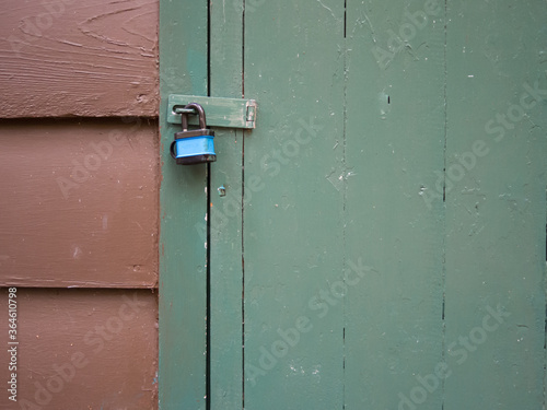 Door latch locked with a flimsy padlock