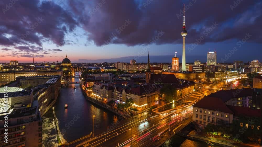 Berlin, Germany, day to night timelapse view of Berlin skyline including iconic TV Tower and tour boats on the Spree river.