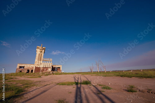 Abandoned town. City abandoned by a flood, in Epecuen ghost town. Dead trees in the lake with its houses in ruins. Desolate landscape photo