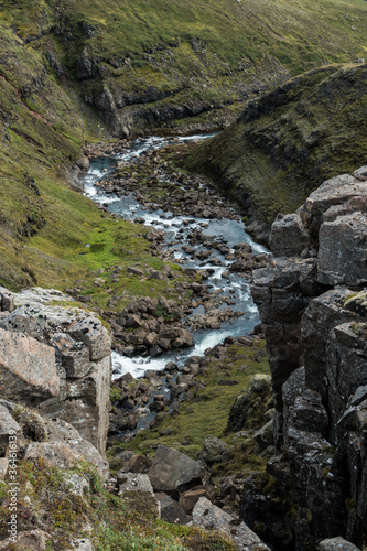 Stream of water between hills and rocks