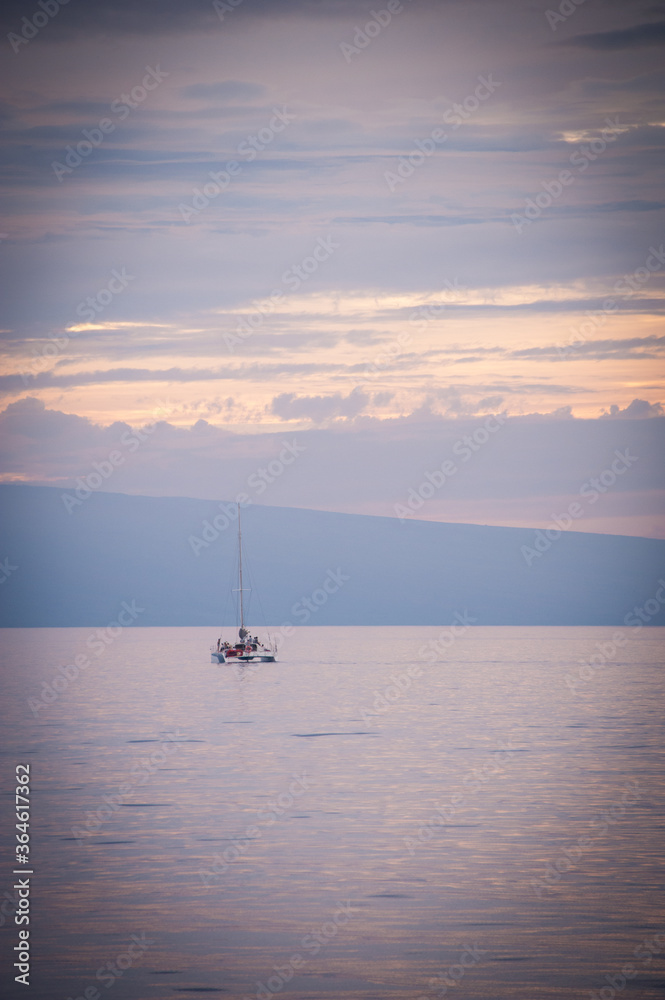 sailboat at sunset, calm ocean