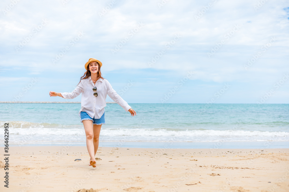 Happy young girl walking on the beach. Summer travel, vocation, holiday concept. Happy young girl walking on the beach. Summer travel, vocation, holiday concept.