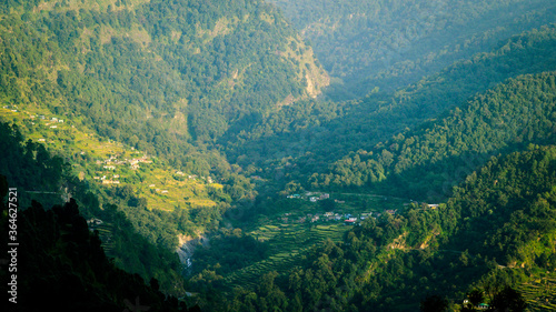 Scenic North Indian villages in Himalaya, surrounded by hills, dense trees, and farmland. Sari village, Rudraprayag, Uttarakhand