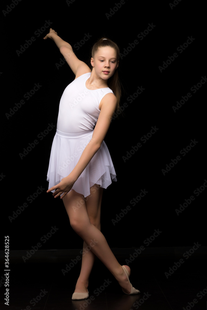 Naklejka premium Full length portrait of a charming gymnast girl in elegant dress.