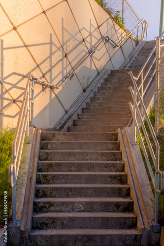 Fototapeta Naklejka Na Ścianę i Meble -  Stairwell Lit By Golden Light