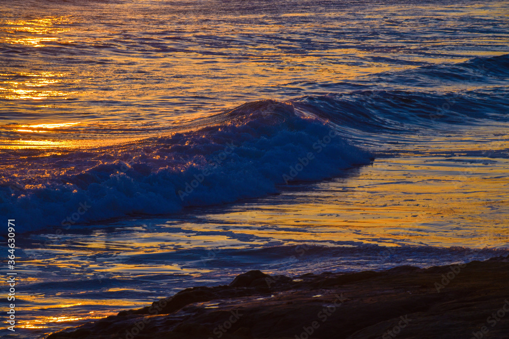 Brilliant sunset  suns rays reflecting on ocean waves