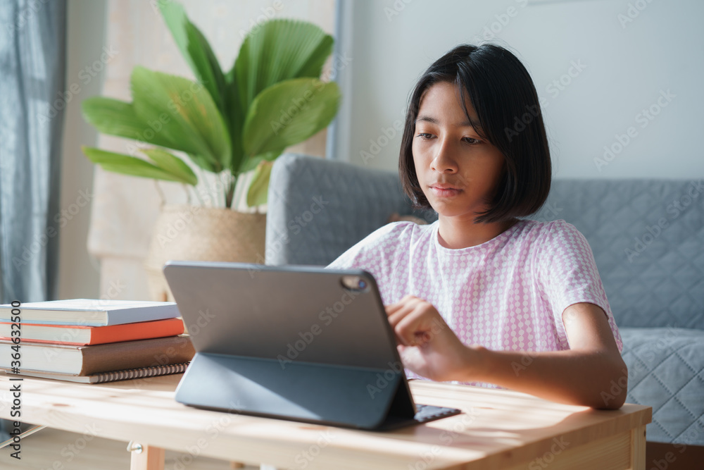 homeschooling. Asian girl learning with online tutor on tablet digital homeschooling. Asian girl learning with online tutor on tablet digital