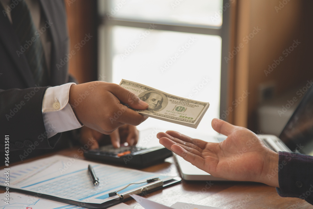 close up of businessman with calculator counting money. in the company room. close up of businessman with calculator counting money. in the company room.