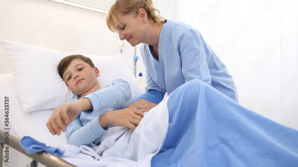Nurse puts child to sleep in the hospital bed Nurse puts child to sleep in the hospital bed