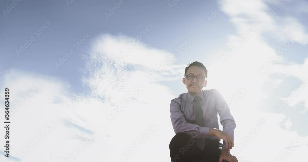 A Concept of Freedom from Covid-19 Pandemic. Low Angle of Young Malay Man in Office Wear Throwing Face Mask Away Then Smiles under Bright Backlight from Morning Sun that Produced Lens Flare. A Concept of Freedom from Covid-19 Pandemic. Low Angle of Young Malay Man in Office Wear Throwing Face Mask Away Then Smiles under Bright Backlight from Morning Sun that Produced Lens Flare.