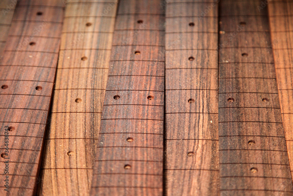 Guitar factory showing raw wood and guitars in the different stages of