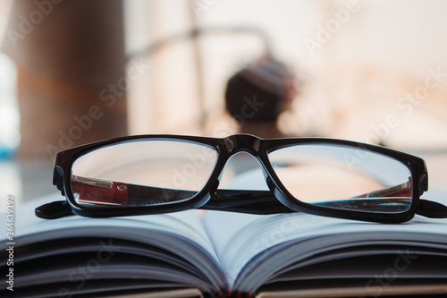 Glasses on top of the book