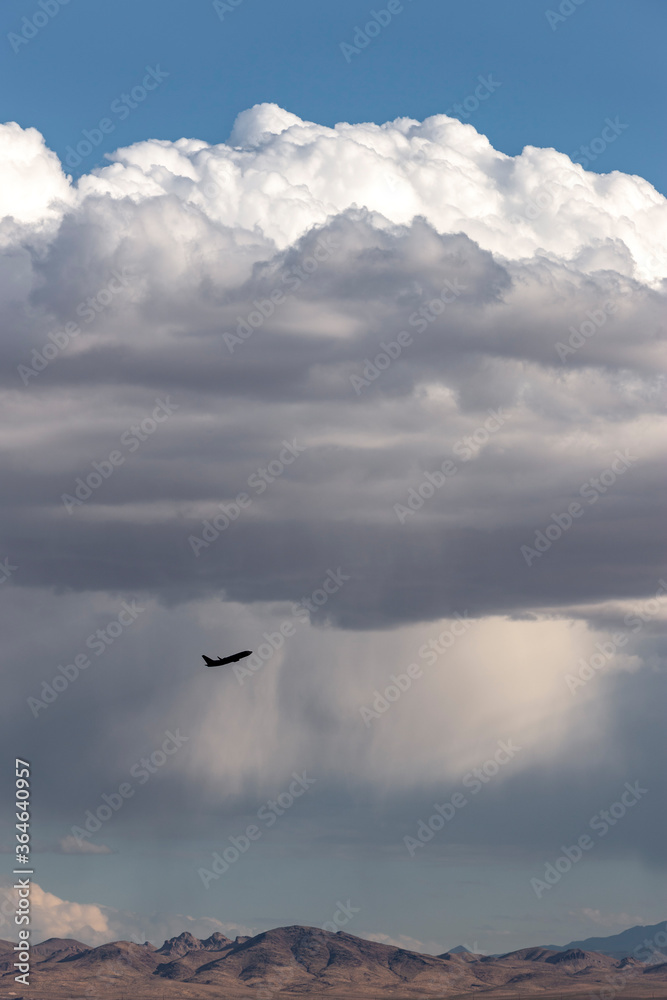 Fototapeta premium Aircraft taking off with a rainstorm in the background.