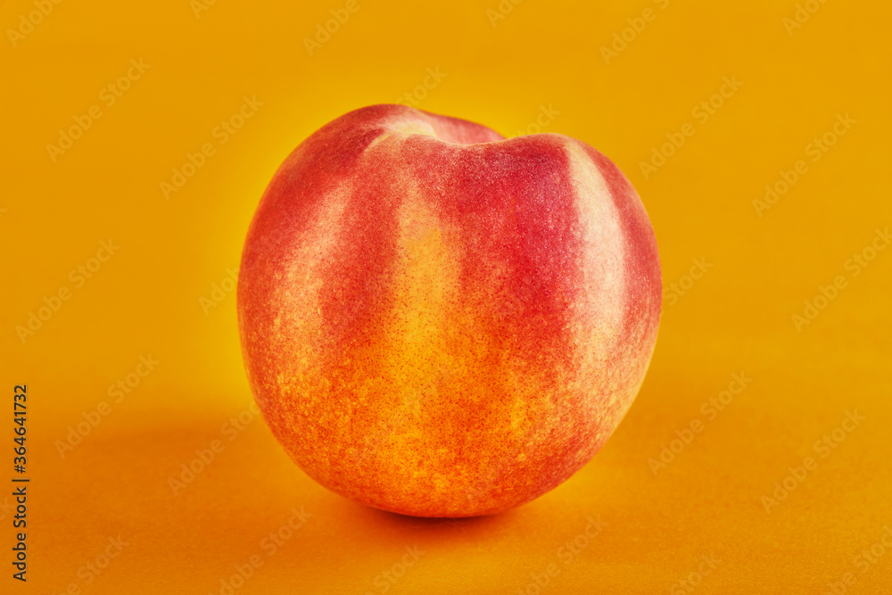 Fresh juicy peach isolated on an orange background Fresh juicy peach isolated on an orange background