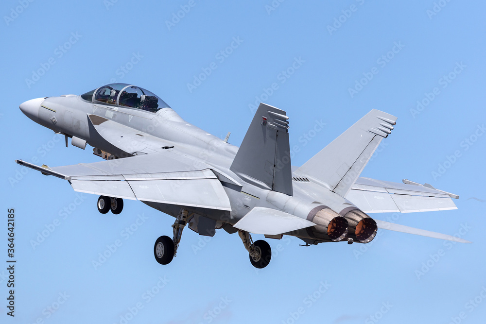 F/A-18F Super Hornet multirole fighter aircraft taking off into a blue sky. F/A-18F Super Hornet multirole fighter aircraft taking off into a blue sky.